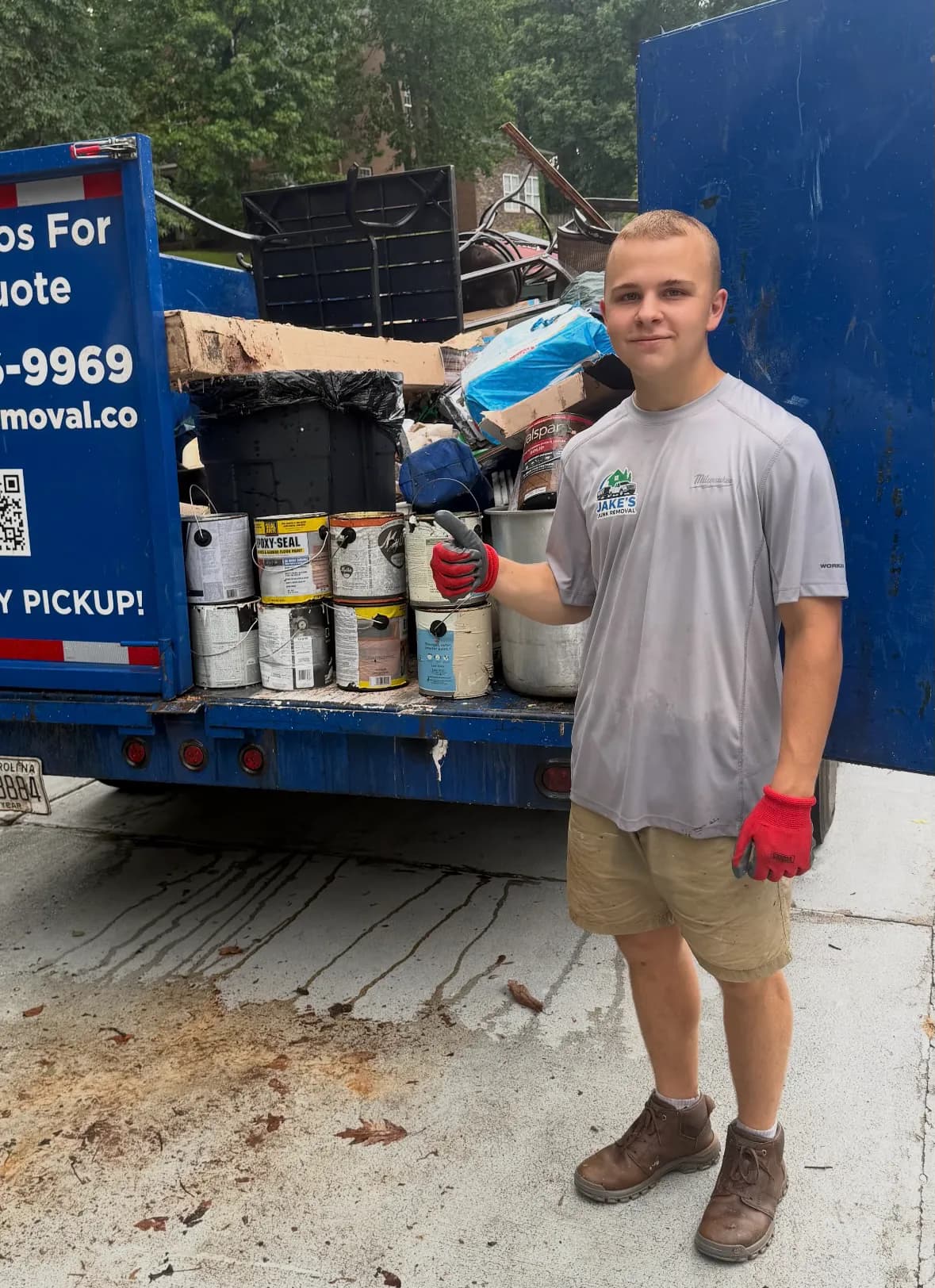 Jake's Junk Removal crew loading a trailer